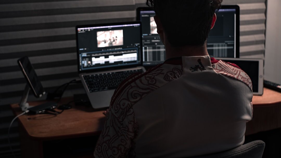 Professional video editor working on post-production at a high-end workstation